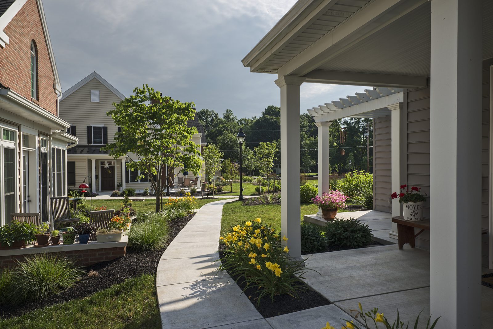 covered porch and curving sidewalk between townhomes