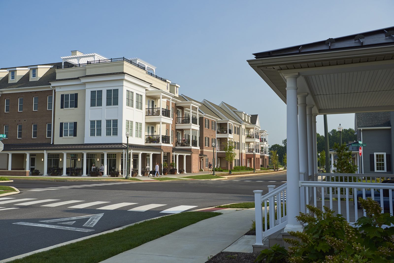 Corner view of apartment building and homes along the streetfront