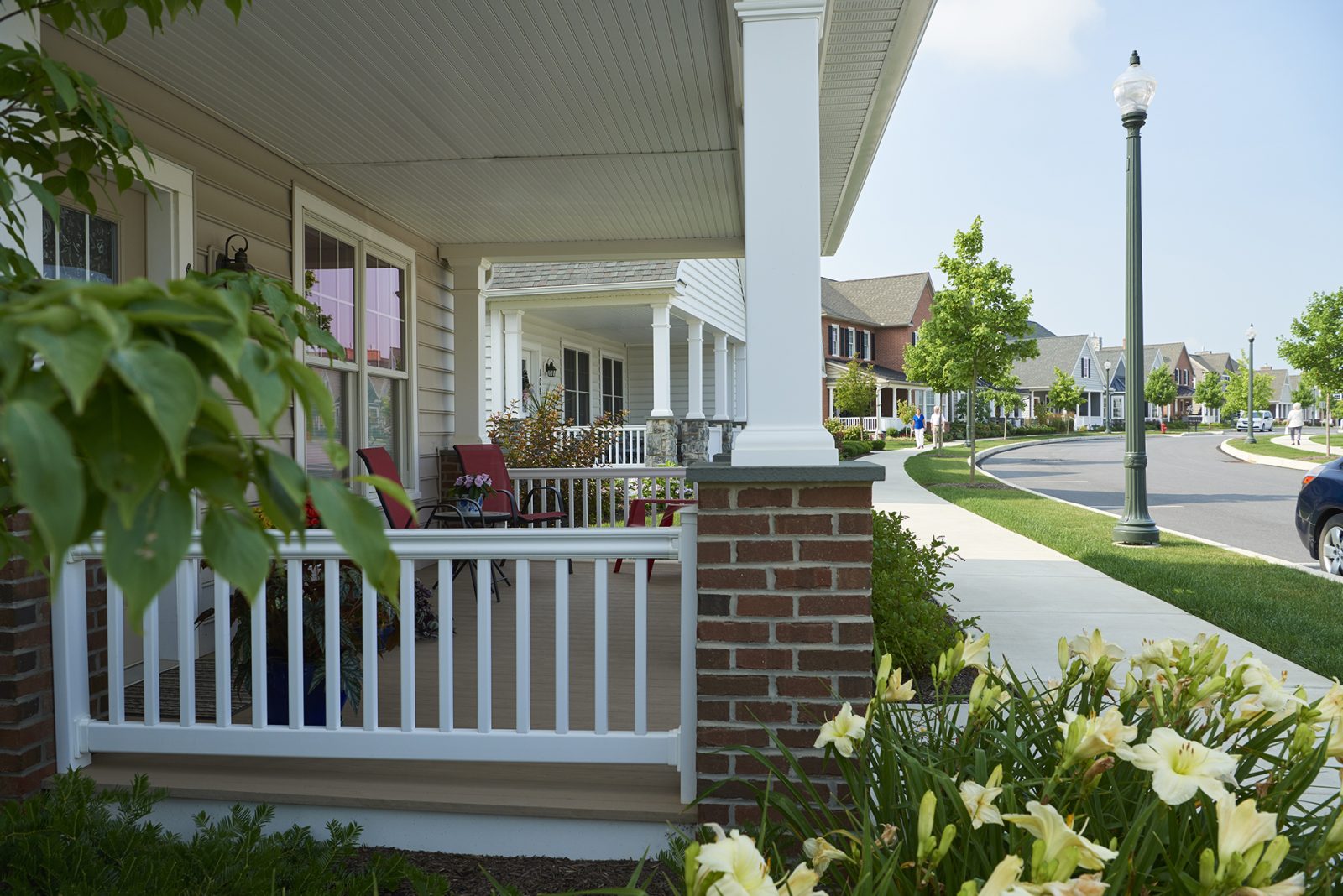 Homes along a curved street with porch in foreground