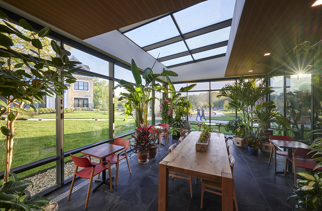 Greenhouse adjacent to test kitchen provides year round gardening activities and biophilic benefits 