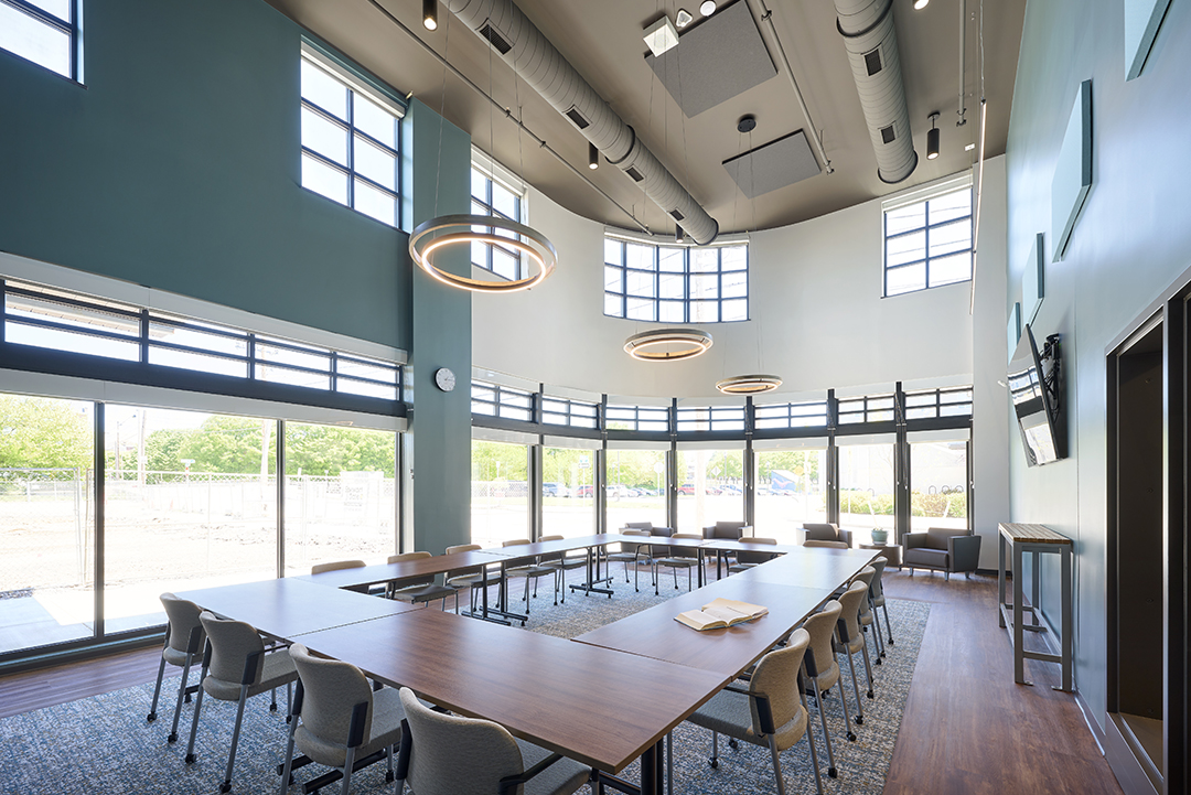 Meeting space at Logos Academy retains original facade with bank of curved windows