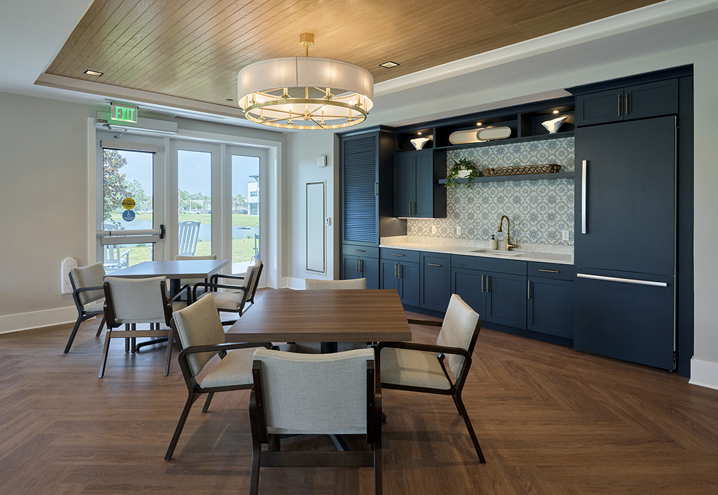 Community multi-purpose space with tables and chairs and built-in kitchenette