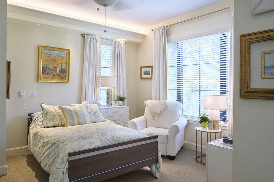 Skilled nursing room with bed and lots of daylight from windows on two sides