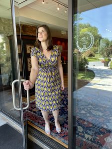 Woman Opening Door with WELL Seal