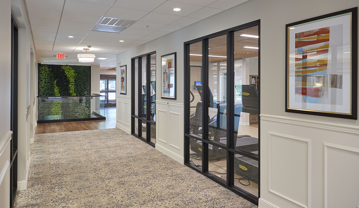 Corridor outside gym with green wall at opposite end