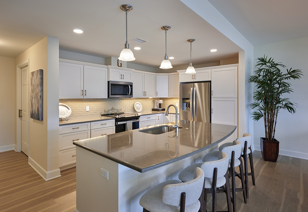 Bright, modern kitchens open onto large open living spaces.