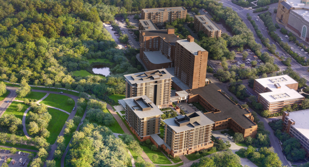 Aerial view of URC, a multi-story brick apartment buildings on campus with lots of trees
