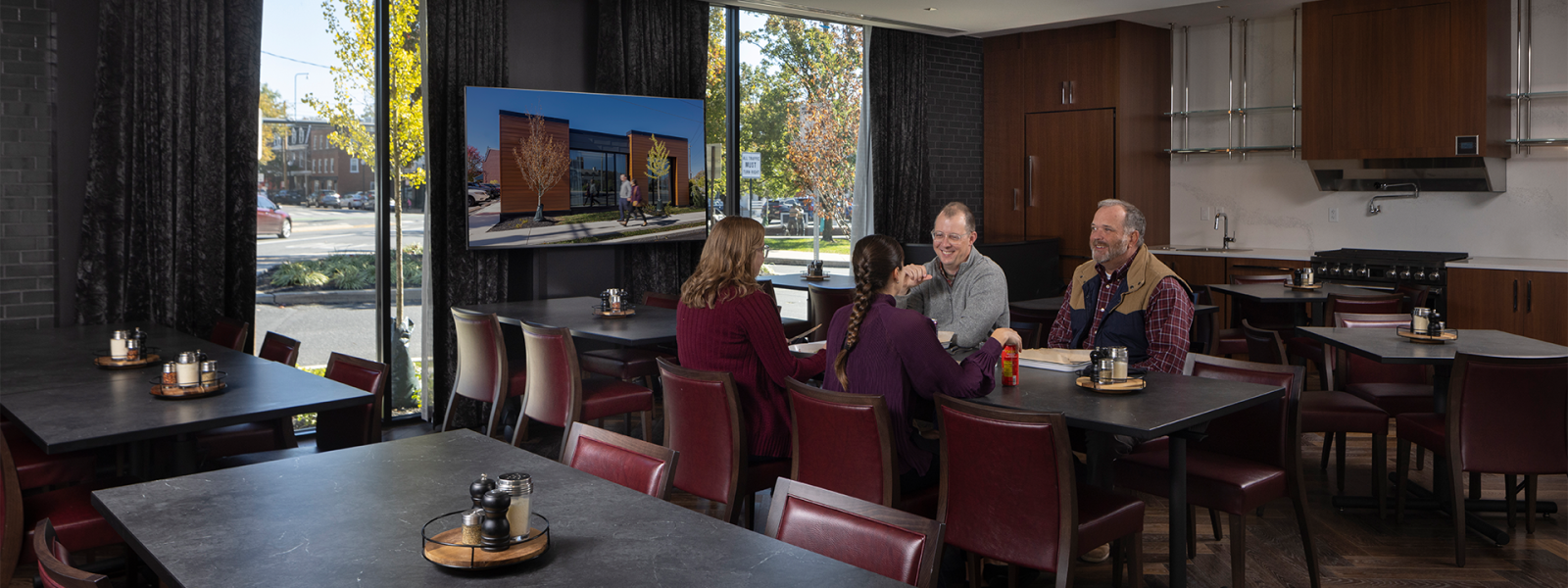A formal dining room with a demonstration kitchen in an upscale restaurant