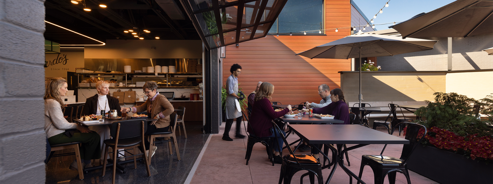 Roll-up garage doors connect patio dining with the deli & bistro seating