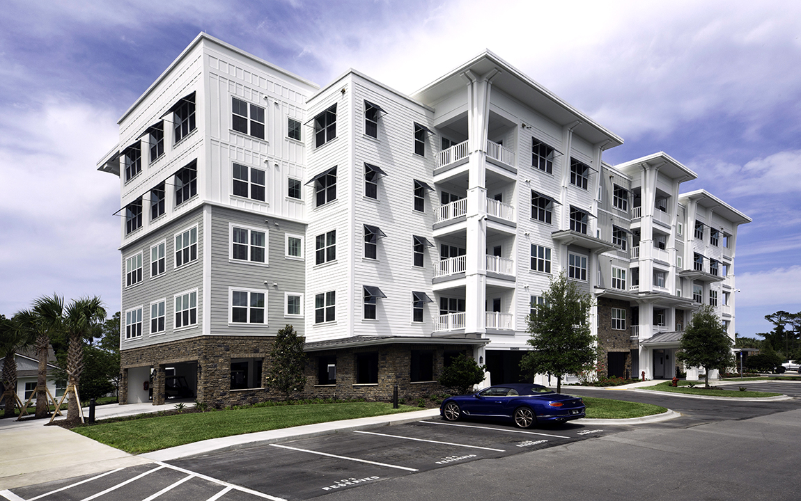 Multi-story hybrid senior living apartment building with under building parking for cars and golf carts