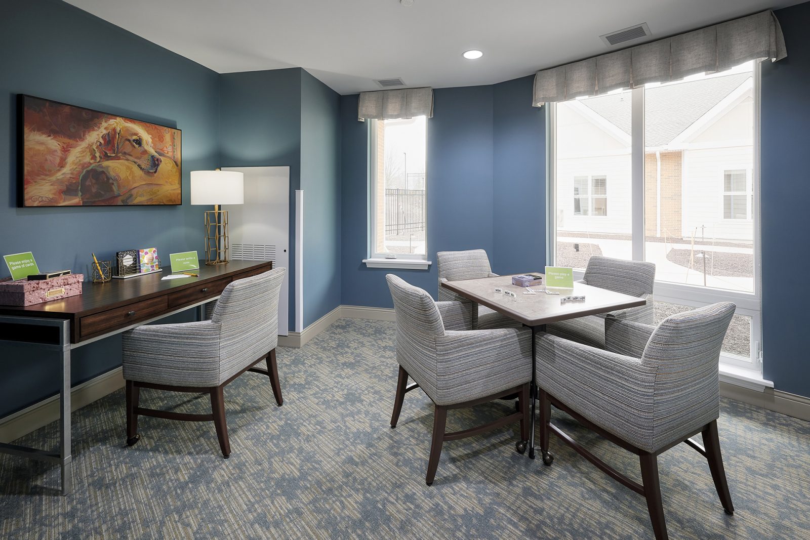 Memory care neighborhoods social space with table and desk for resident use