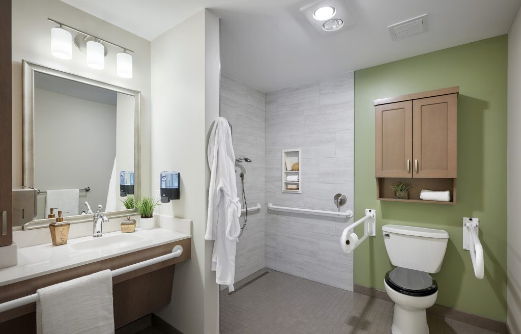 Accessible and senior-friendly bathroom in resident room in memory care neighborhood