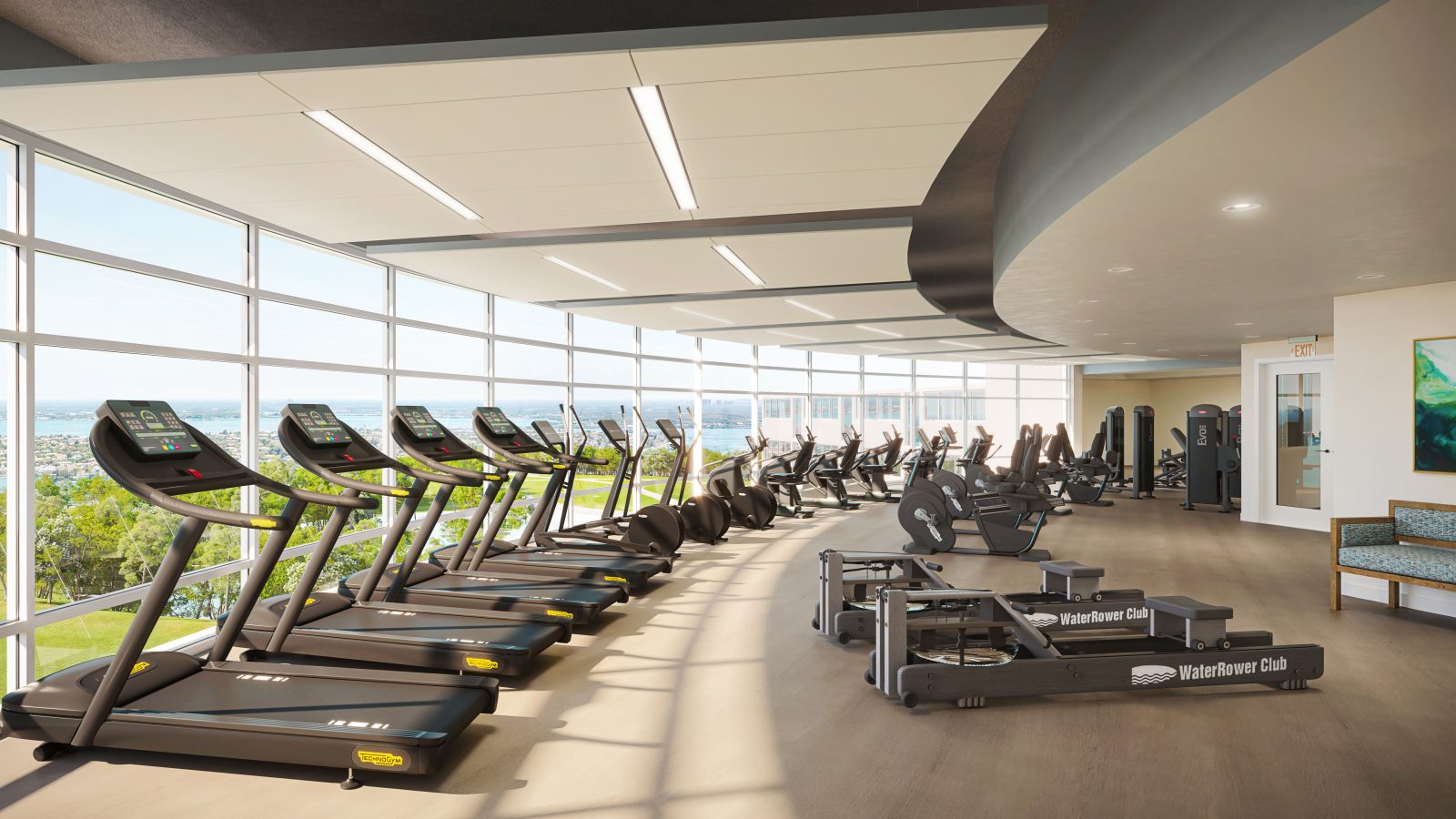 fitness center with wall of windows overlooking a bay