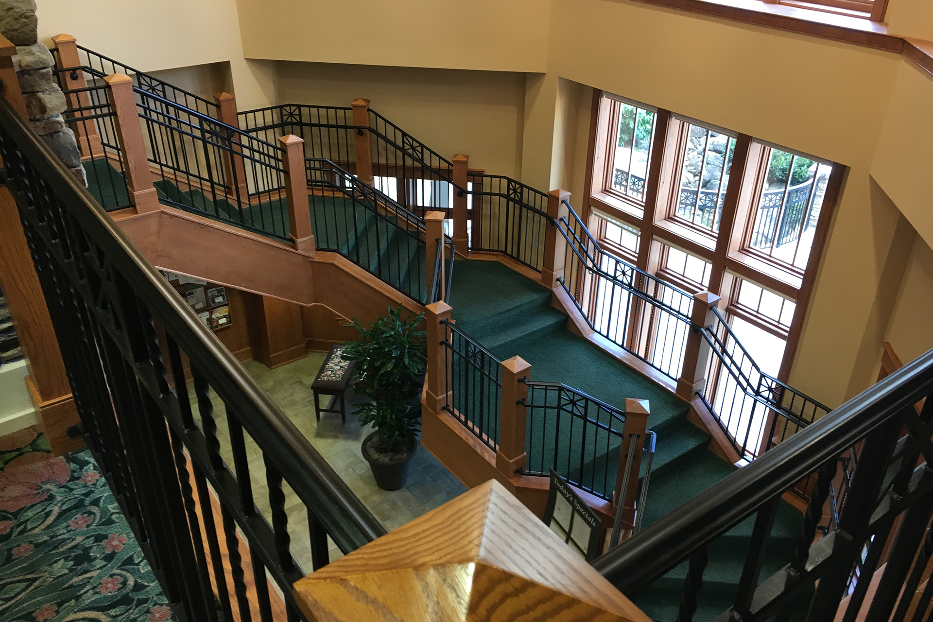 Open grand stair with wall of windows before interior renovations